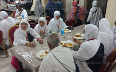 Umrah Pilgrims at the dining table having their breakfast